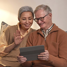 Photo of an older couple having a video call session on their tablet. This represents how neuropsychological evaluations in Texas can help you plan your recovery process.