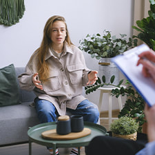Photo of a woman talking to a neuropsychologist during a psychological assessment. This illustrates how these evaluations can help identify specific conditions or disorders, marking the starting point for your journey toward progress.